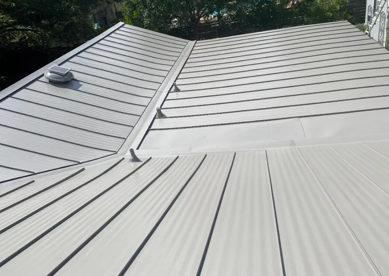 Solar attic fan installed on a metal roof for Roof Ventilation in Solvay